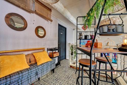 a living room with a couch and a table at Hotel Des Artistes in Tarascon