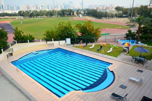 an overhead view of a large swimming pool at Dubai Youth Hotel in Dubai