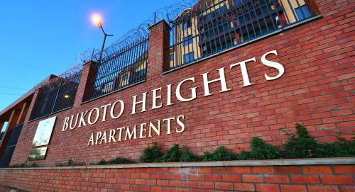 a brick building with a sign that reads buffalo heightsagents at Bukoto Heights Apartments in Kampala