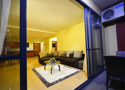 a living room with a couch and a table at Bukoto Heights Apartments in Kampala