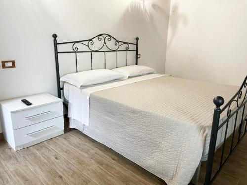 a bedroom with a black bed and a night stand at Tenuta Morrone in Pertosa