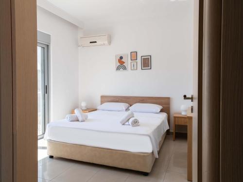 Habitación blanca con cama y ventana en Apartment Santa Marina 6, en Asgourou