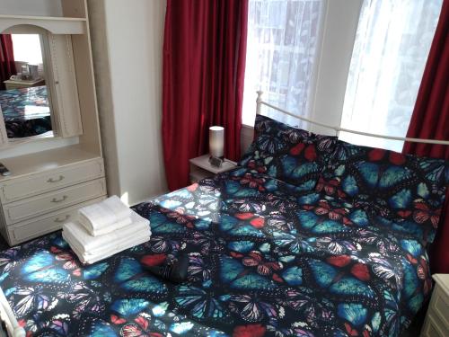 a bedroom with a bed with a colorful comforter at Southview Hotel in Blackpool