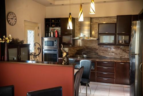 a kitchen with a counter and a refrigerator at House with Garden near the Beach in Heraklio