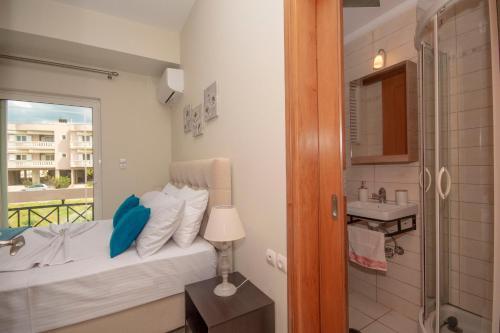 a bedroom with a bed and a bathroom with a window at Jasmine House Kissamos in Kissamos