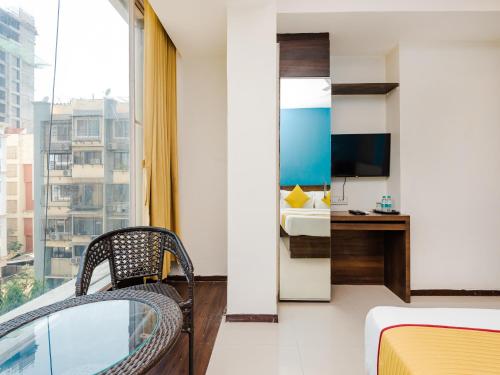 a hotel room with a bed and a window at Hotel Aura - Near Malad Link Road in Mumbai
