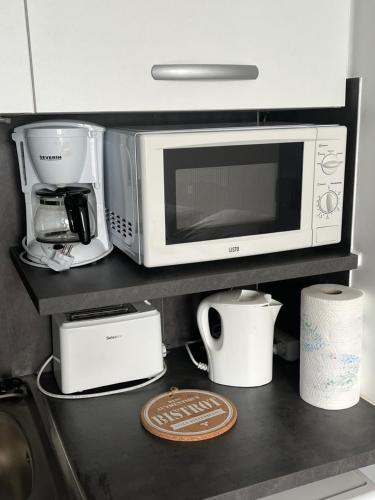 a microwave and other appliances on a kitchen counter at Vivez la Marina - Plage - Port de plaisance in Le Havre