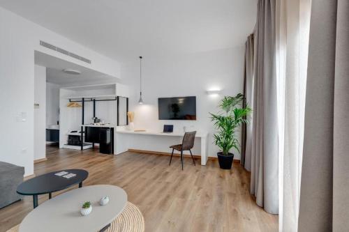 a living room with a table and a desk at Marion Suite in Ermoupoli