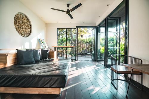 a living room with a couch and a table at iWualai Hotel in Chiang Mai