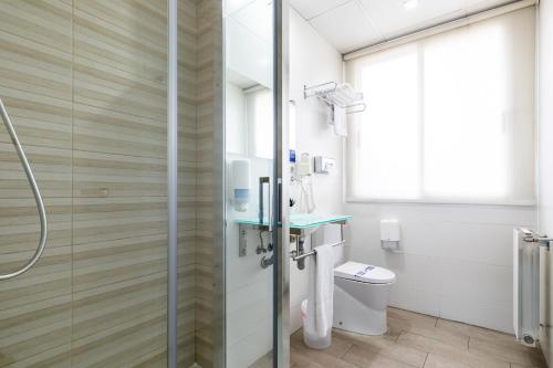 a bathroom with a shower and a toilet at Sweet Hotel Renasa in Valencia