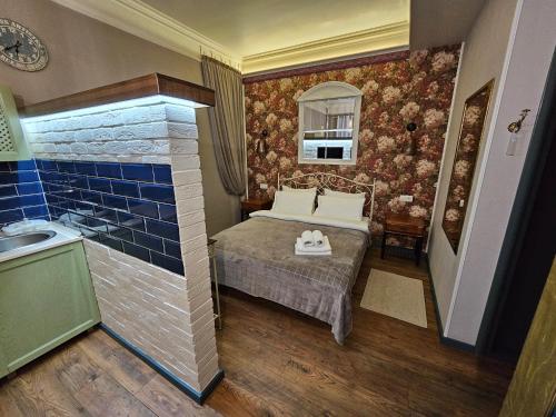a small bedroom with a bed and a sink at Studios on Grigore Vieru in Chişinău