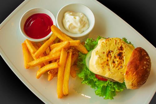 a plate of food with a sandwich and french fries at Hotel Del Luna Boutique in Da Nang