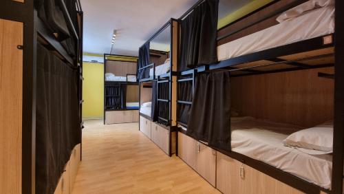 a hallway with three bunk beds in a room at Onefam Les Corts in Barcelona