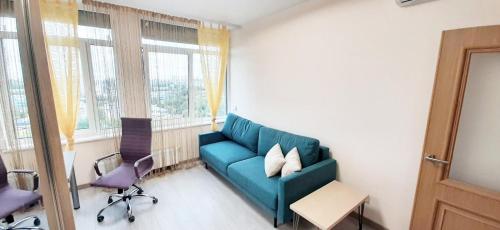 a living room with a blue couch and two chairs at FlatService Затишні та просторі апартаменти в ЖК Parklend in Kyiv