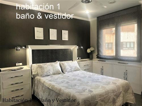 a bedroom with a bed with a dresser and aintendent at ALBACETE CENTRO PARKING GRATIS 2 PLAZAS in Albacete