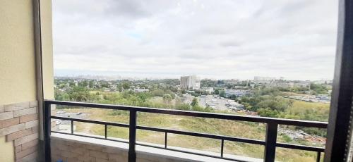 a view of a city from a window at FlatService Затишні та просторі апартаменти в ЖК Parklend in Kyiv