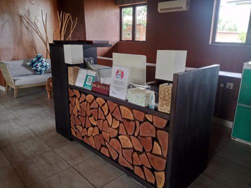 a counter with a pile of fire wood at Trois Ore Residences & Green Earth Bistro in Ibadan