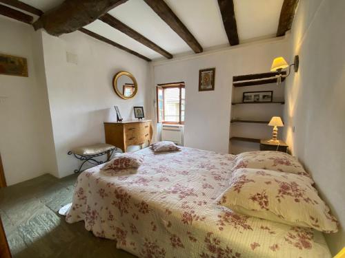 a bedroom with a bed and a desk and a window at Borgo Village in Borgo