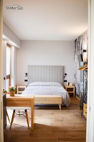 a bedroom with a bed and a wooden table at GuerriniBNB Civico 5 in Manerbio
