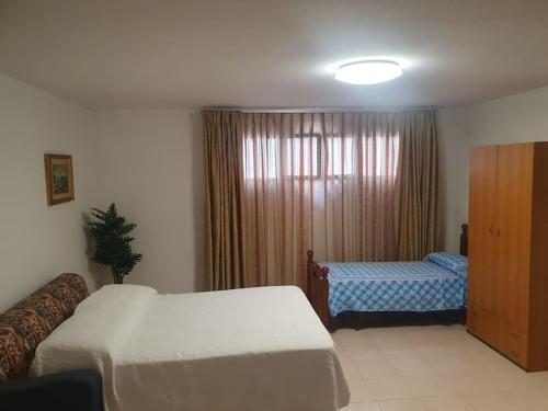 ロゾリーニにあるcasa vacanza Nonna Linaのベッド2台と窓が備わるホテルルームです。