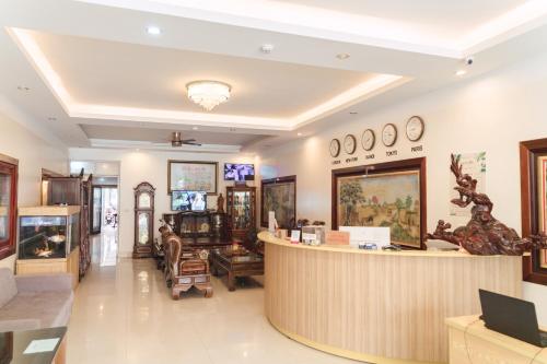 a lobby of a furniture store with a reception counter at Luxury Airport Hotel Travel in Noi Bai
