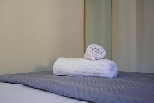 a stack of towels sitting on top of a bed at MariMar in Balíon
