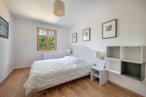 - une chambre blanche avec un lit et une fenêtre dans l'établissement Charmante villa tout confort et à 500 m de la plage à Pornichet, à Pornichet