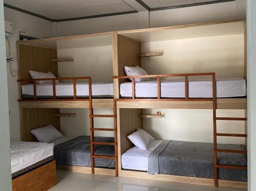 a room with four bunk beds in a room at LORENT HOSTEL Nipah in Padang