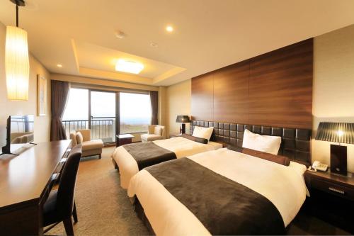 Habitación de hotel con 2 camas y escritorio en FOURTREAT plus NASUKOGEN, en Nasu