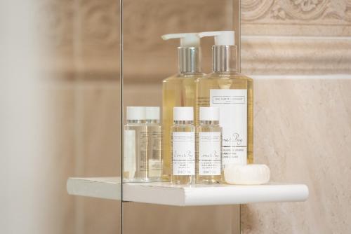 a shelf with four bottles of soap on it at Barbican House in York