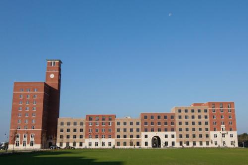 a group of buildings with a clock tower at UPP Bay Campus Swansea in Swansea