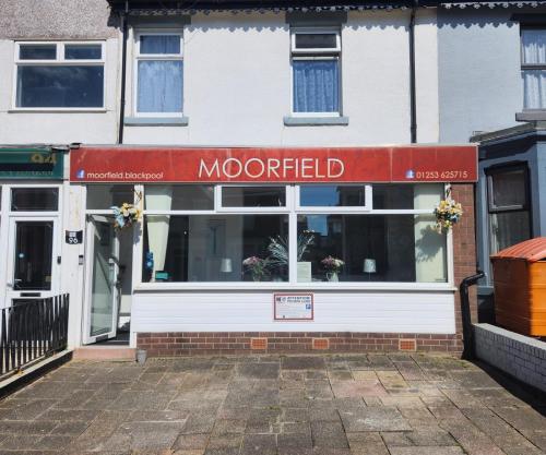 a store with a red and white sign in front of it at The Moorfield in Blackpool