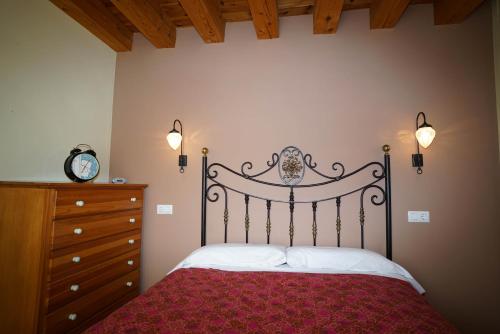 a bedroom with a bed and a dresser at Casa Arnedillo by Apartamentos Arnedillo in Arnedillo