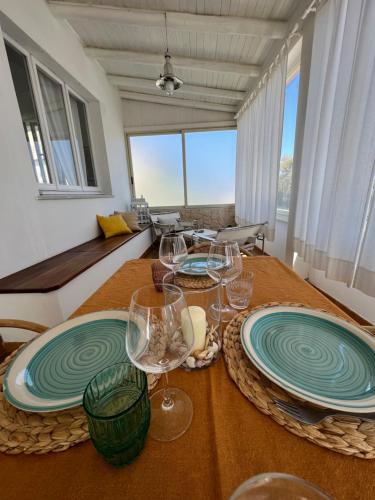 a dining room with two tables with plates and wine glasses at Da u Franchin in Carloforte