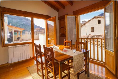 a dining room with a table and chairs on a balcony at Casa Arnedillo in Arnedillo