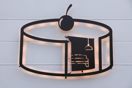 a mirror hanging on a wall with a chair in it at 鴝花甜點民宿 QuHua Sweety B&B in Dongshan