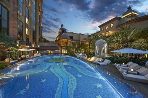 a large swimming pool in front of a building at Mandarin Oriental, Taipei in Taipei
