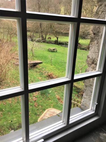 a window with a view of a green field at Jopes Mill and Lodge in Looe