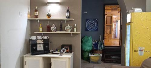 a room with a kitchen with a counter with a microwave at Le Plejadi in Castellammare del Golfo