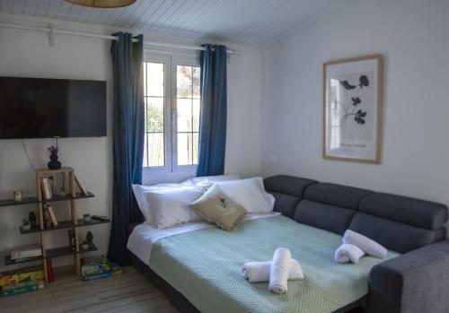 um quarto com um sofá e toalhas numa cama em MariMar em Balíon