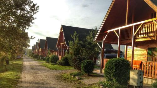 a row of houses on a dirt road at Sárberki Horgásztó in Lenti