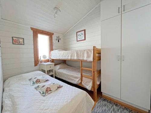 1 dormitorio con 2 literas y ventana en Paritalomökki Lomariihi 10, en Muurame