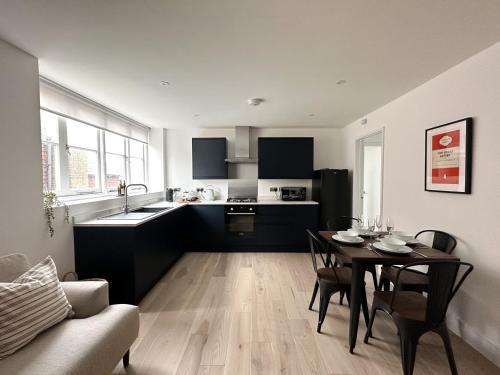 a kitchen and living room with a dining table and a kitchen at The Loft, NEW, Stylish Maisonette, Central, Private Location in Lewes
