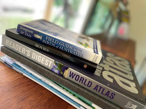 a stack of books sitting on top of a table at Nolan garden house in whitfield in Stratford