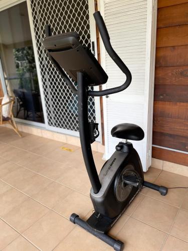 a exercise bike sitting on the floor of a house at Nolan garden house in whitfield in Stratford
