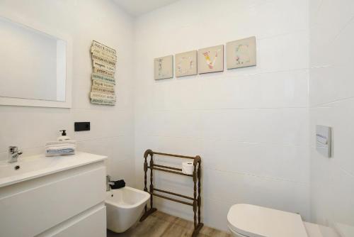 a white bathroom with a toilet and a sink at Villa Ocean View - Costa Adeje - Near Golf - Tenerife South - Canary Islands - Spain in Armeñime