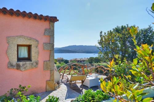 a view of a house with a view of the water at Case Vacanze La Conia in Cannigione