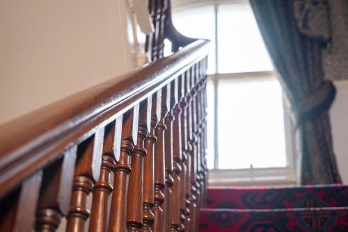 a wooden stairway with a window and a stair case at Barbican House in York