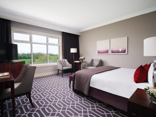 a hotel room with a bed and a desk and chair at Lyrath Estate in Kilkenny