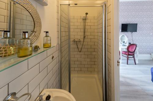a bathroom with a shower and a sink at Highlands Hotel and bar in Hastings